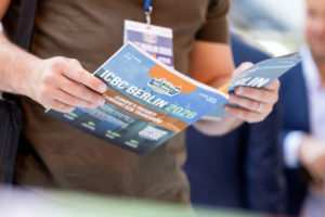 person holding icbc Berlin 2026 magazine