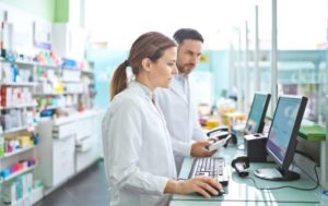 Pharmacists looking at a computer