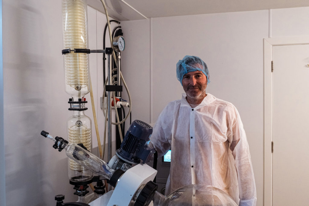 Man next to RX Extraction lab machinery