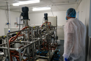 Man next to RX Extraction lab machinery
