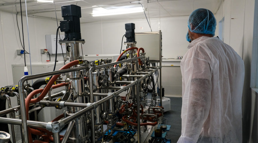 Man next to RX Extraction lab machinery